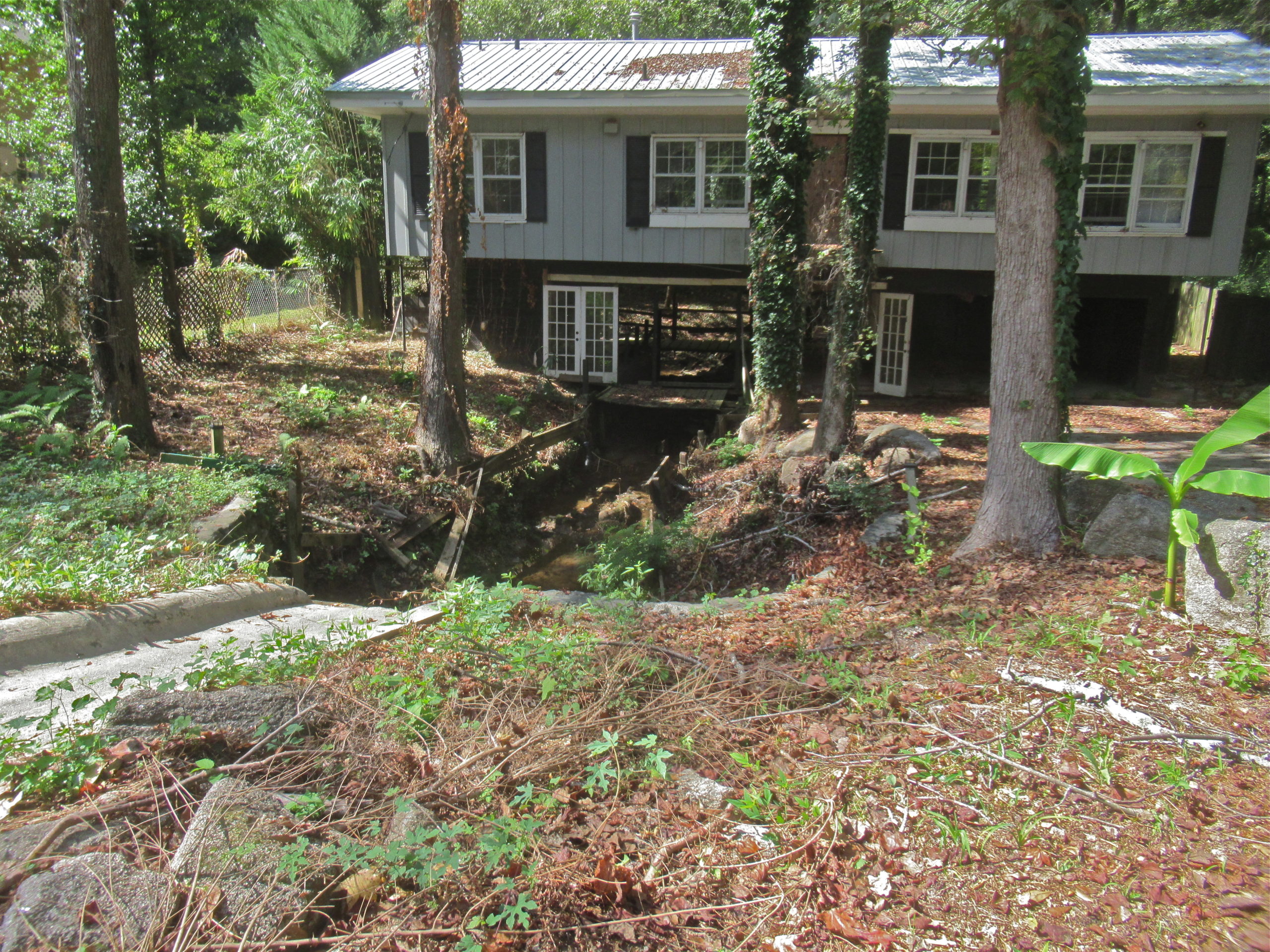 Creek flowing under home